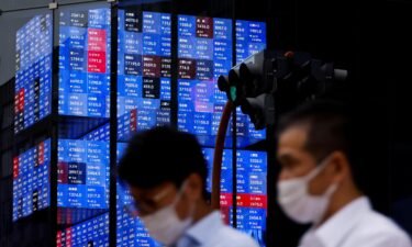 Asian markets are on track for their worst month since the pandemic began. People pass by a screen showing Japan's Nikkei share price index in Tokyo on June 14.