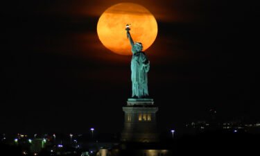 September's harvest moon will appear a deep orange color as it ascends into the sky.