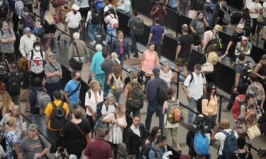 Travelers queue up at the south security checkpoint in Denver International Airport as the Labor Day holiday approaches
