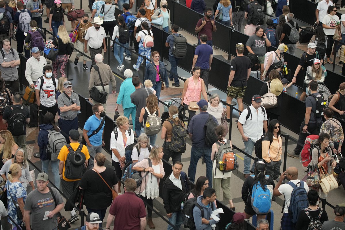 <i>David Zalubowski/AP</i><br/>Travelers queue up at the south security checkpoint in Denver International Airport as the Labor Day holiday approaches