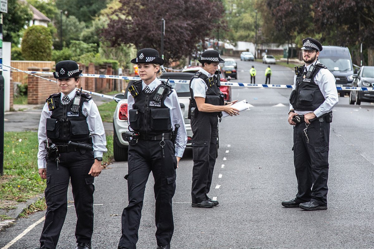 <i>Thabo Jaiyesimi/SOPA Images/Sipa USA/Reuters</i><br/>Police officers stand on guard at the crime scene in Kirkstall Gardens.