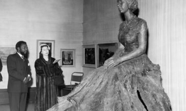 Ben Enwonwu and HM Elizabeth II are pictured here looking at his sculpture of the Queen.