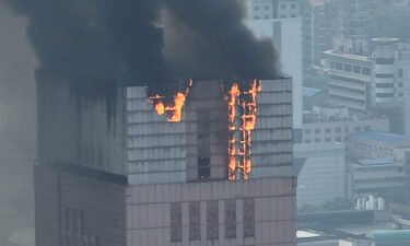 Flames and smoke rise from the 218-meter-tall office building in Changsha on September 16.