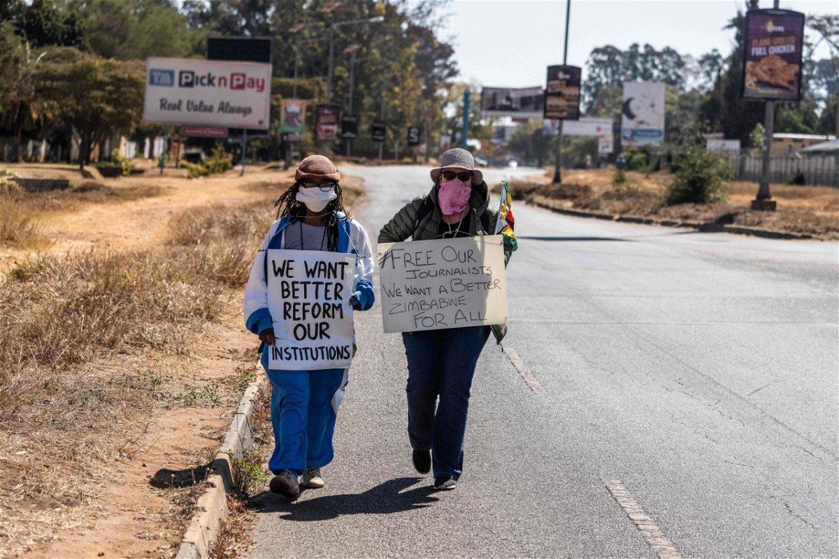 <i>Zinyange Auntony/AFP/Getty Images</i><br/>Zimbabwean novelist Tsitsi Dangarembga (left) and colleague Julie Barnes hold placards during an anti-corruption protest march in July of 2020 in Harare.