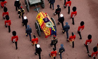 Queen Elizabeth II's flag-draped coffin is taken in procession on a gun garriage of The King's Troop Royal Horse Artillery from Buckingham Palace to Westminster Hall on September 14