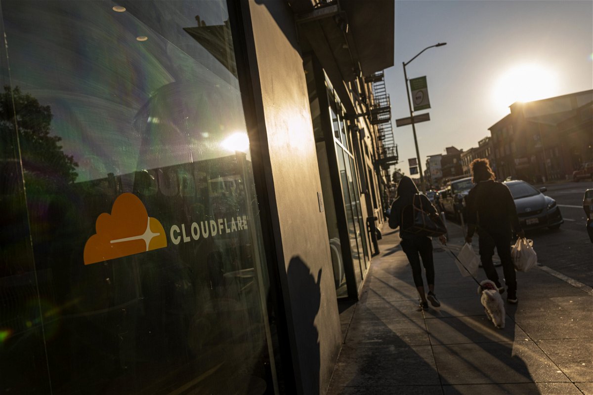 <i>David Paul Morris/Bloomberg/Getty Images</i><br/>Pedestrians outside the Cloudflare headquarters in San Francisco