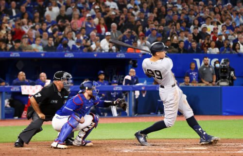 Wife of Toronto Blue Jays coach jokes about 'divorce' after watching her husband give away Aaron Judge's lucrative home run ball. Judge is pictured here hitting his 61st home run of the season.