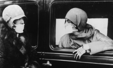 Two women are seen wearing flu masks during a flu epidemic in 1929.