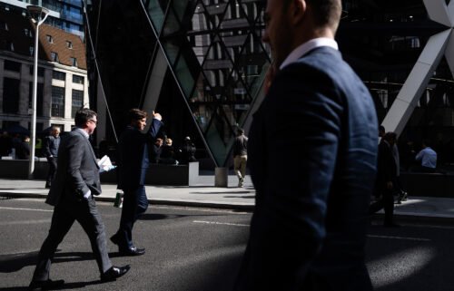 City workers are seen walking in the City of London