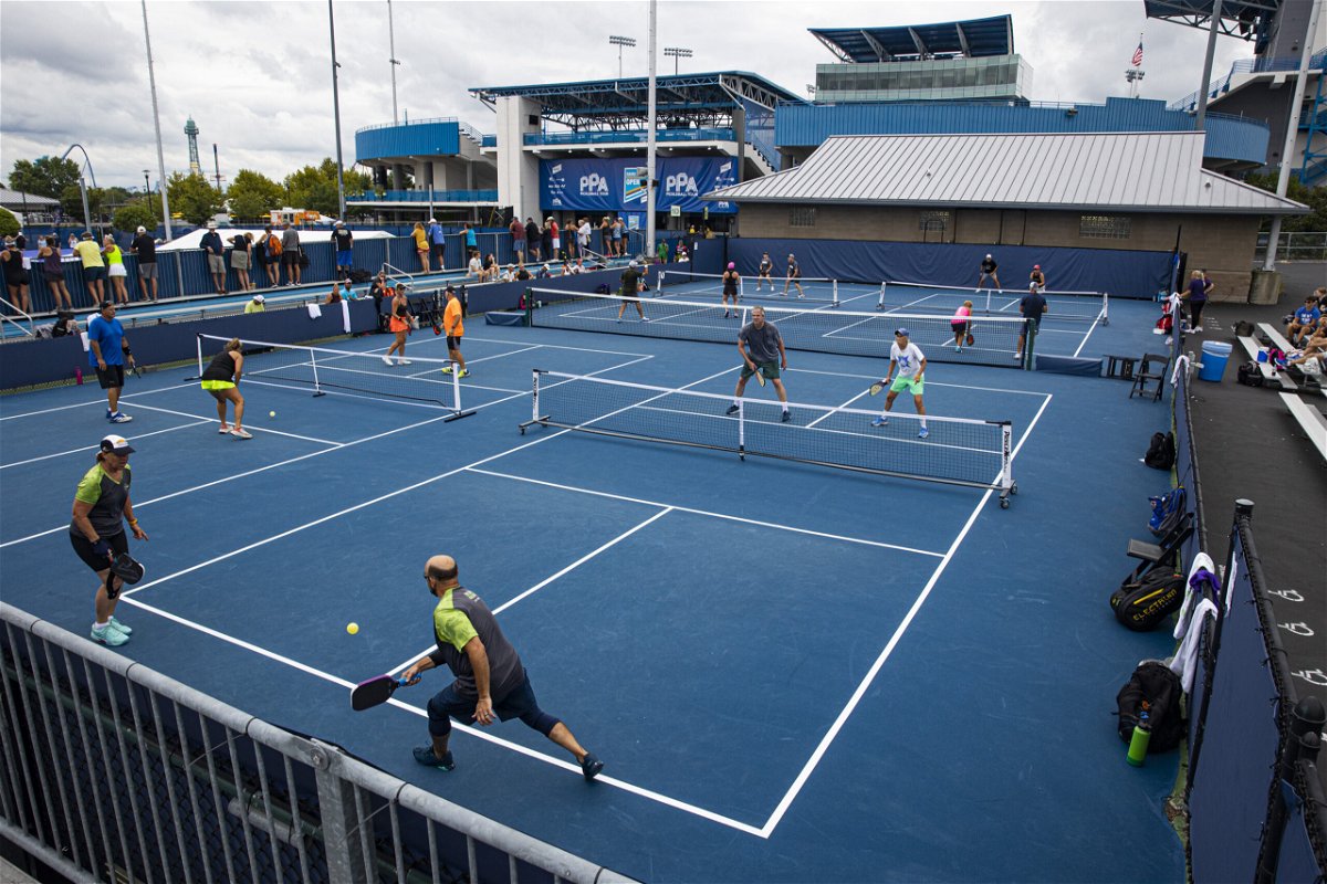<i>Arden S. Barnes/The Washington Post/Getty Images</i><br/>Amateur pickleball players play mixed double matches during the Professional Pickleball Association Baird Wealth Management Open.