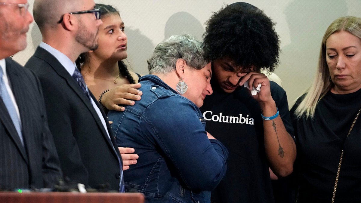 <i>Kyle Robertson/Columbus Dispatch/USA Today</i><br/>Donovan Lewis' mother Rebecca Duran is embraced as the police body camera footage of the deadly shooting is shown at a press conference.