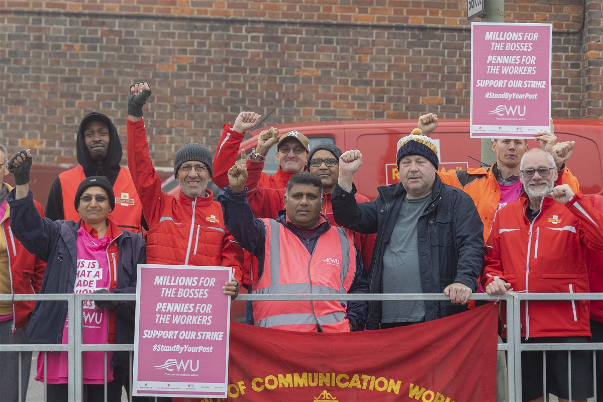 <i>Rasid Necati Aslim/Anadolu Agency/Getty Images</i><br/>Royal Mail postal workers join a Communication Workers Union strike outside a post office in London on September 30. Royal Mail workers have walked out for a 48-hour strike from today as a dispute over pay escalates.