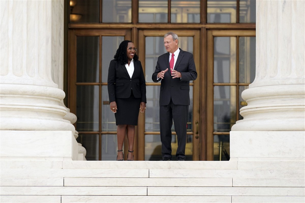 <i>Carolyn Kaster/AP</i><br/>Justice Ketanji Brown Jackson (left) stands outside the Supreme Court with Chief Justice John Roberts following her formal investiture ceremony on September 30.