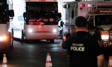 A bus carrying migrants who crossed the border from Mexico into Texas arrives at the Port Authority bus station in Manhattan on August 25.
