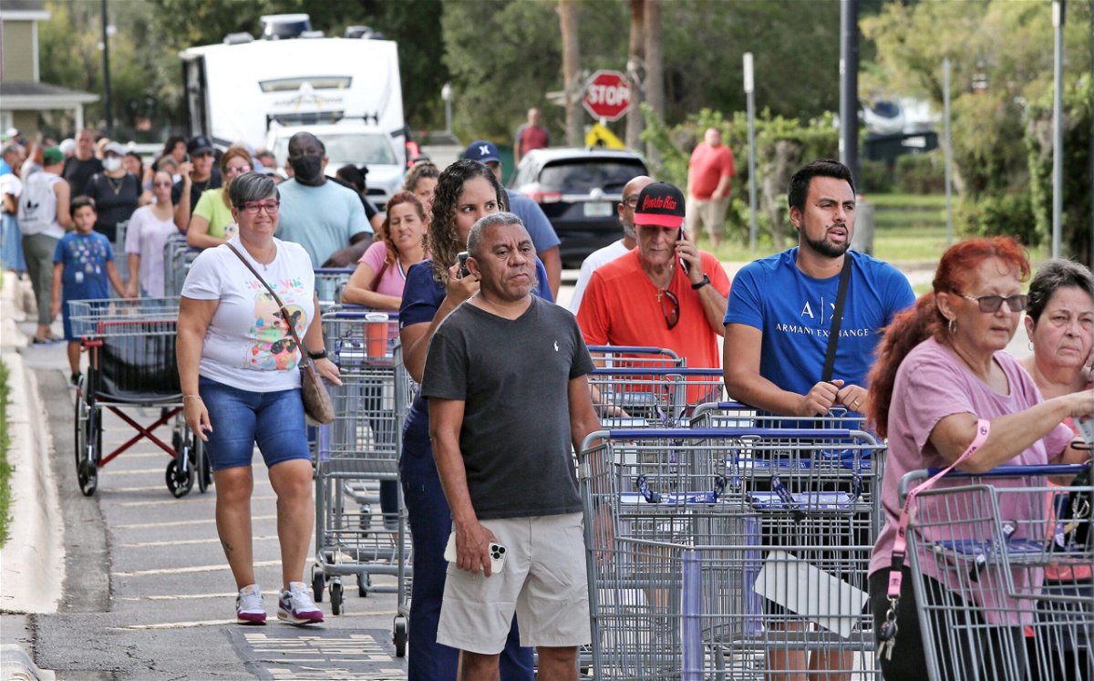 <i>Gregg Newton/AFP/Getty Images</i><br/>Shoppers wait in line on September 25 as people rush to prepare for Hurricane Ian in Kissimmee