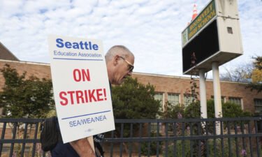 Math teacher Royce Christensen pickets outside Roosevelt High School in Seattle on what was supposed to be the first day of classes.