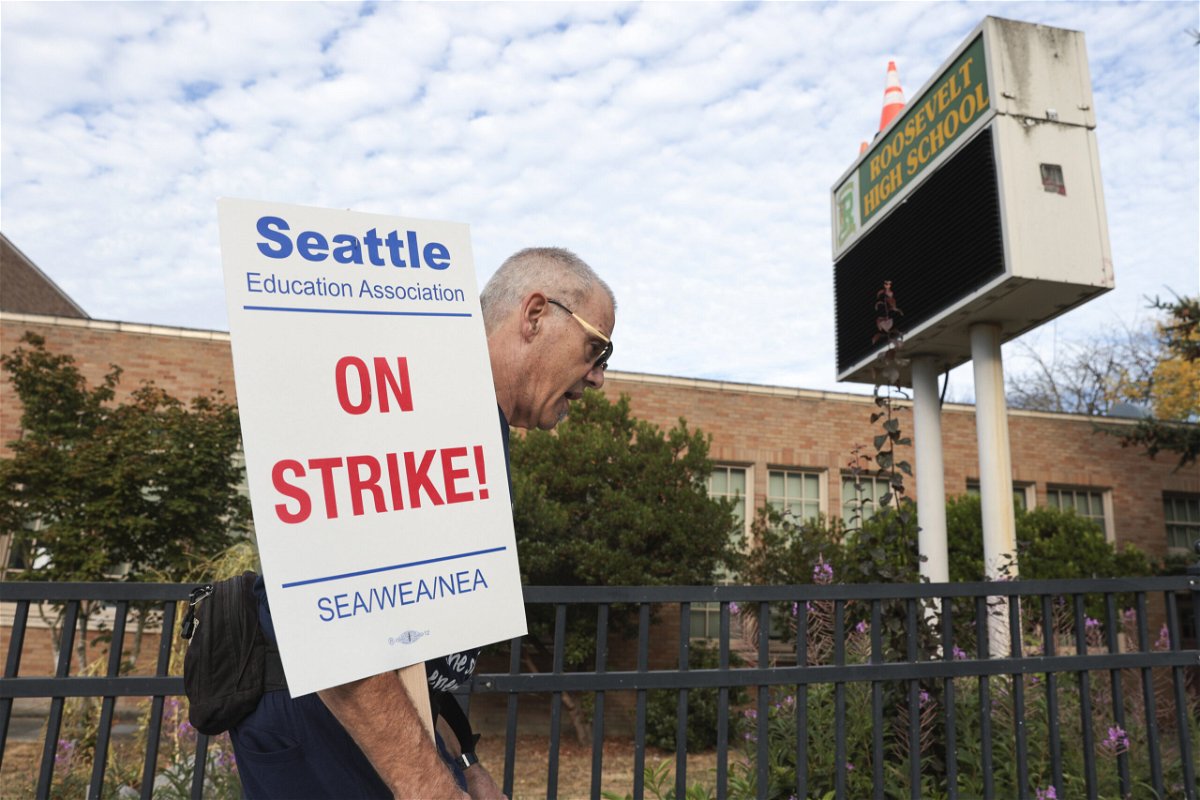 <i>Jason Redmond/AP</i><br/>Math teacher Royce Christensen pickets outside Roosevelt High School in Seattle on what was supposed to be the first day of classes.