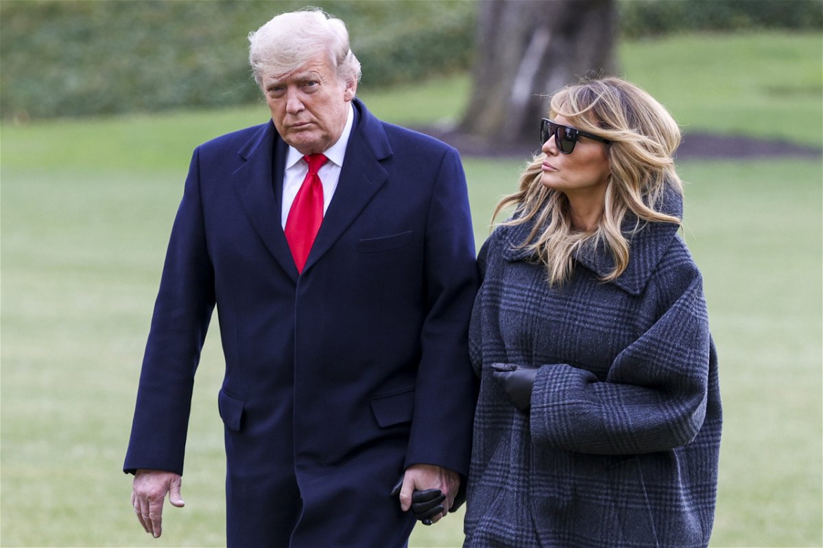 <i>Tasos Katopodis/Getty Images</i><br/>Then-President Donald Trump and First Lady Melania Trump walk on the South Lawn while returning to the White House on December 31