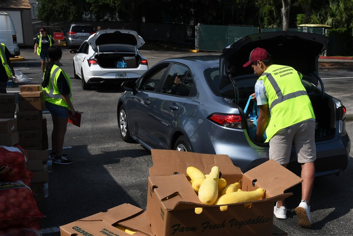 <i>Paul Hennessy/SOPA Images/LightRocket/Getty Images</i><br/>The Biden White House seeks to tackle food insecurity at the first hunger conference since 1969. Volunteers are pictured here  loading bags of food into cars at a food distribution event for the needy in Orlando