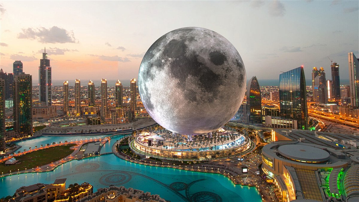 <i>Moon World Resorts Inc.</i><br/>A Dubai cityscape is pictured at sunset.  The city is illuminated in the bottom portion of the frame by synthetic light