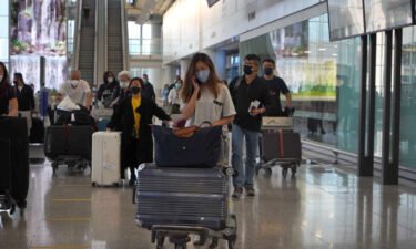 Passengers are seen here arriving at Hong Kong International Airport on September 26.