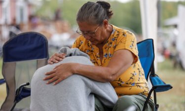 Annie Sanderson comforts her granddaughter on September 5 after a stabbing spree killed 10 people on the James Smith Cree Nation reserve and nearby town of Weldon