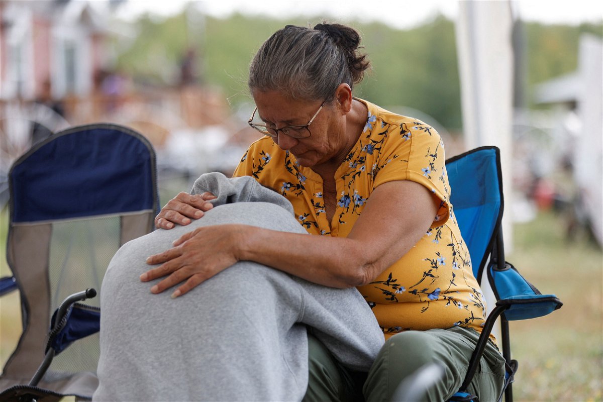 <i>David Stobbe/Reuters</i><br/>Annie Sanderson comforts her granddaughter on September 5 after a stabbing spree killed 10 people on the James Smith Cree Nation reserve and nearby town of Weldon