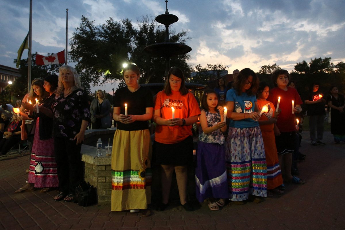 <i>Lars Hagberg/AFP/Getty Images</i><br/>People hold candles during a vigil for the stabbing attack victims in Prince Albert