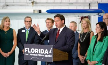 Gov. Ron DeSantis (center) holds a news conference at Embry-Riddle Aeronautical University in Daytona Beach on September 16.