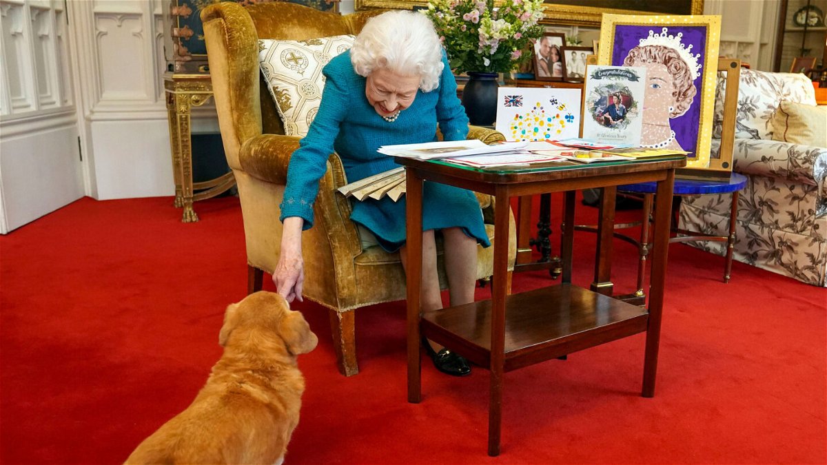 <i>Steve Parsons/WPA Pool/Getty Images</i><br/>Queen Elizabeth II is joined by one of her dogs