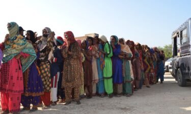 Flood victims line up up to receive food aid at Dera Allah Yar town of Jaffarabad district in Balochistan province on September 17.
