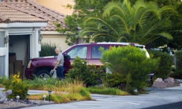 Clark County Public Administrator Robert Telles washes his car outside his home in Las Vegas on September 6.