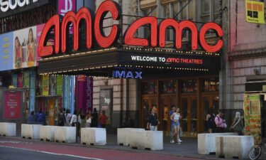 People walk past AMC Theatres in Times Square on August 8 in New York.