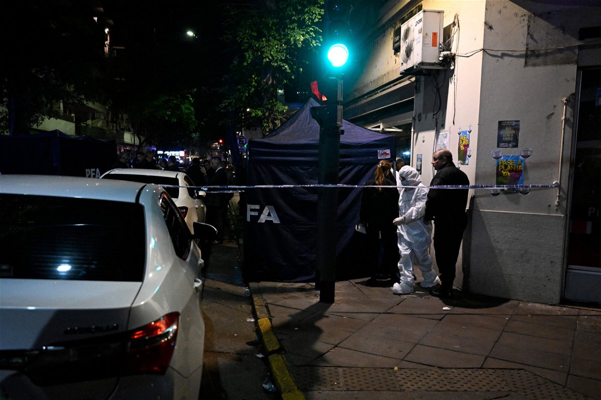 <i>Luis Robayo/AFP/Getty Images</i><br/>Police work behind a security cordon after a man pointed a gun at Argentine Vice-President Cristina Fernandez de Kirchner outside her residence in Buenos Aires on September 1.