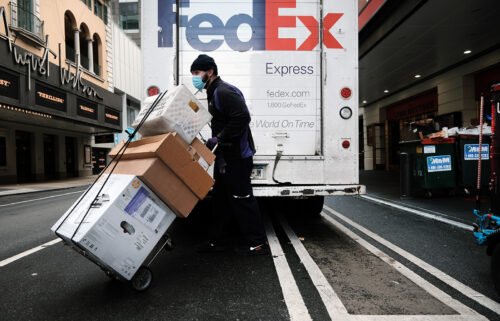 FedEx shares plunged 21% in premarket trading on September 16 after it warned that a slowing economy will cause it to fall $500 million short of its revenue target. A FedEx truck is pictured here making deliveries on December 6 in New York City.