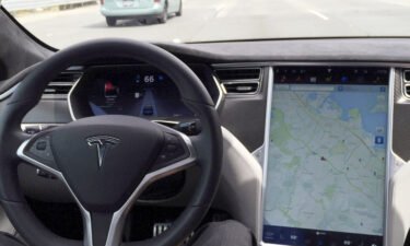 The interior of a Tesla Model S is shown in autopilot mode in San Francisco