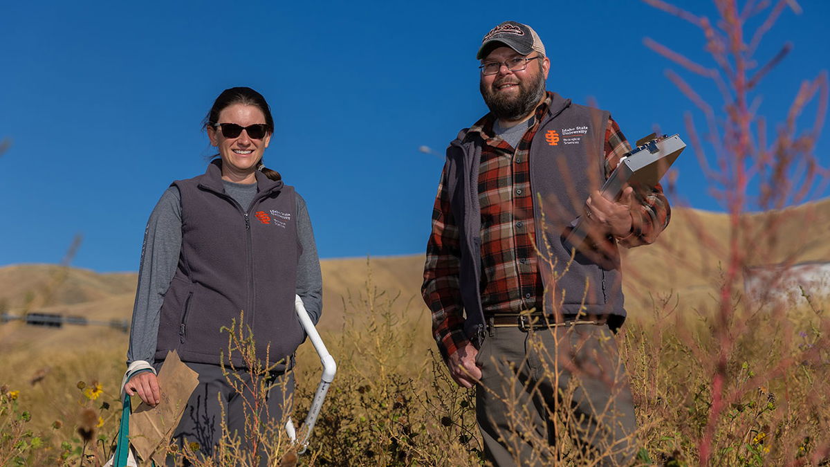 Erika Stewart and Joshua Grinath, assistant professor of community and global change ecology, pose for a photo at an experimental site along Interstate 15 near Inkom on Monday, September 26, 2022. Stewart and Grinath have been working with the Idaho Transportation Department to find out how to make the land hospitable to native plants and resistant to invasive weeds, have increased fire resistance, and be an attractive habitat for pollinators like bees and butterflies.