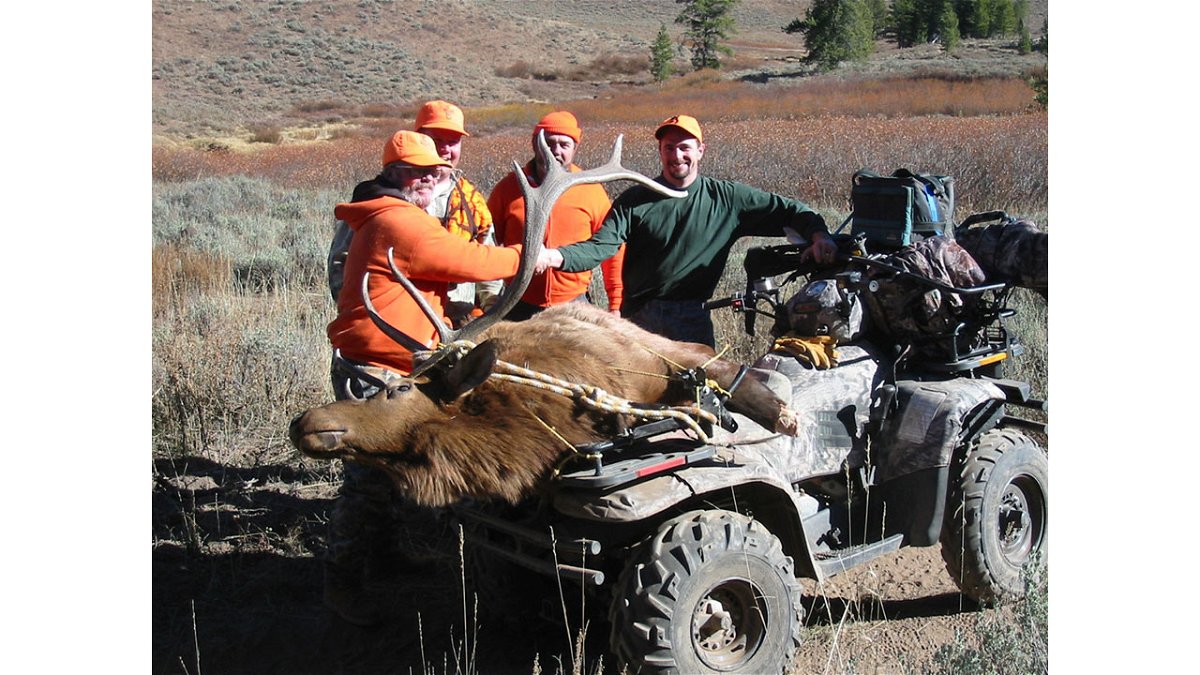 Motorized use hunters with a bull elk on a four wheeler ATV October 2003