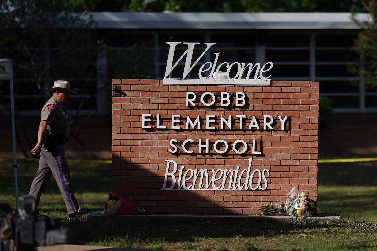 <i>Allison Dinner/AFP/Getty Images</i><br/>An officer walks outside Robb Elementary School in Uvalde
