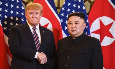 Then-President Donald Trump shakes hands with North Korea's leader Kim Jong Un before a meeting at the Sofitel Legend Metropole hotel in Hanoi on February 27