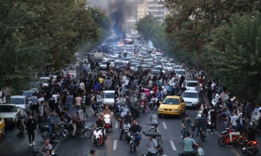 Iranian demonstrators take to the streets of Tehran on September 21 during a protest for Mahsa Amini
