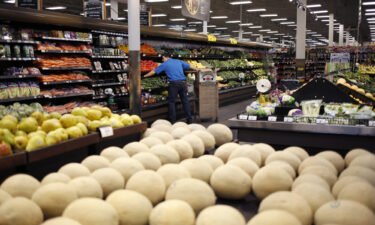 An employee restocks vegetables at a Kroger Co. supermarket in Louisville