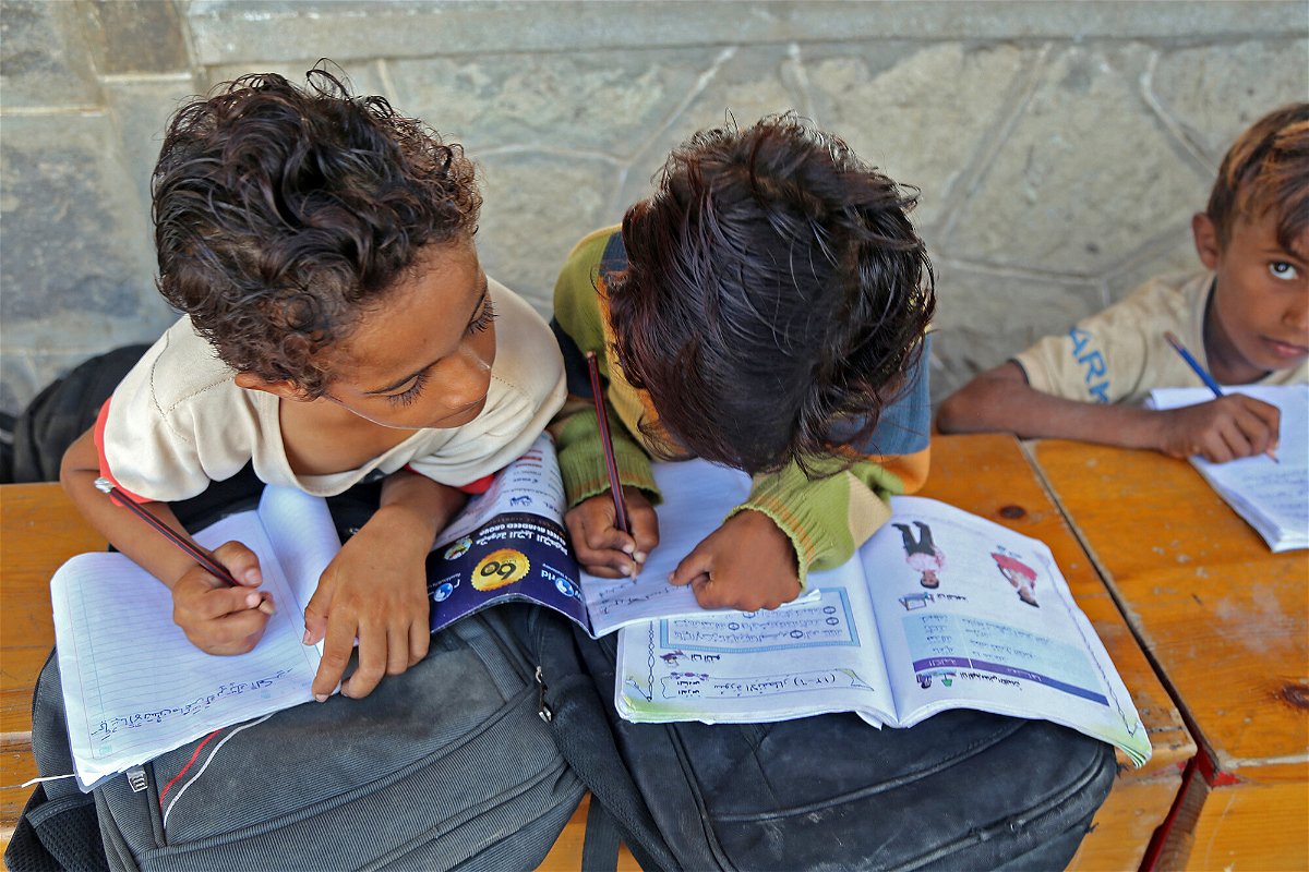 <i>Khaled Ziad/AFP/Getty Images</i><br/>Yemeni children attend class outdoors in a heavily-damaged school on the first day of the new academic year in Yemen's war-torn western province of Hodeida.