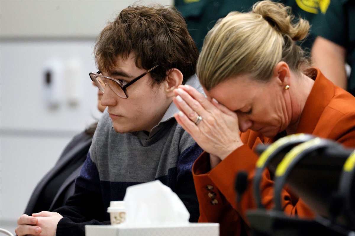 <i>Amy Beth Bennett/South Florida Sun-Sentinel/AP</i><br/>Assistant Public Defender Melisa McNeill (right) touched her hands to her head while sitting next to Nikolas Cruz as the verdicts were read in court on October 13.