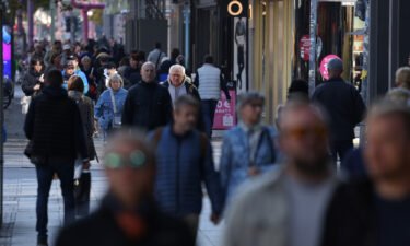 People are pictured walking and shopping in Berlin
