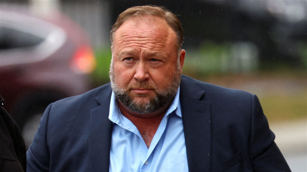 <i>Mike Segar/Reuters</i><br/>Infowars founder Alex Jones prepares to speak to the media on October 4. Jones is seeking a new trial after a Connecticut jury decided this month he should pay $965 million in compensatory damages to eight families of Sandy Hook Elementary School shooting victims and one first responder.