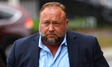 Infowars founder Alex Jones prepares to speak to the media on October 4. Jones is seeking a new trial after a Connecticut jury decided this month he should pay $965 million in compensatory damages to eight families of Sandy Hook Elementary School shooting victims and one first responder.