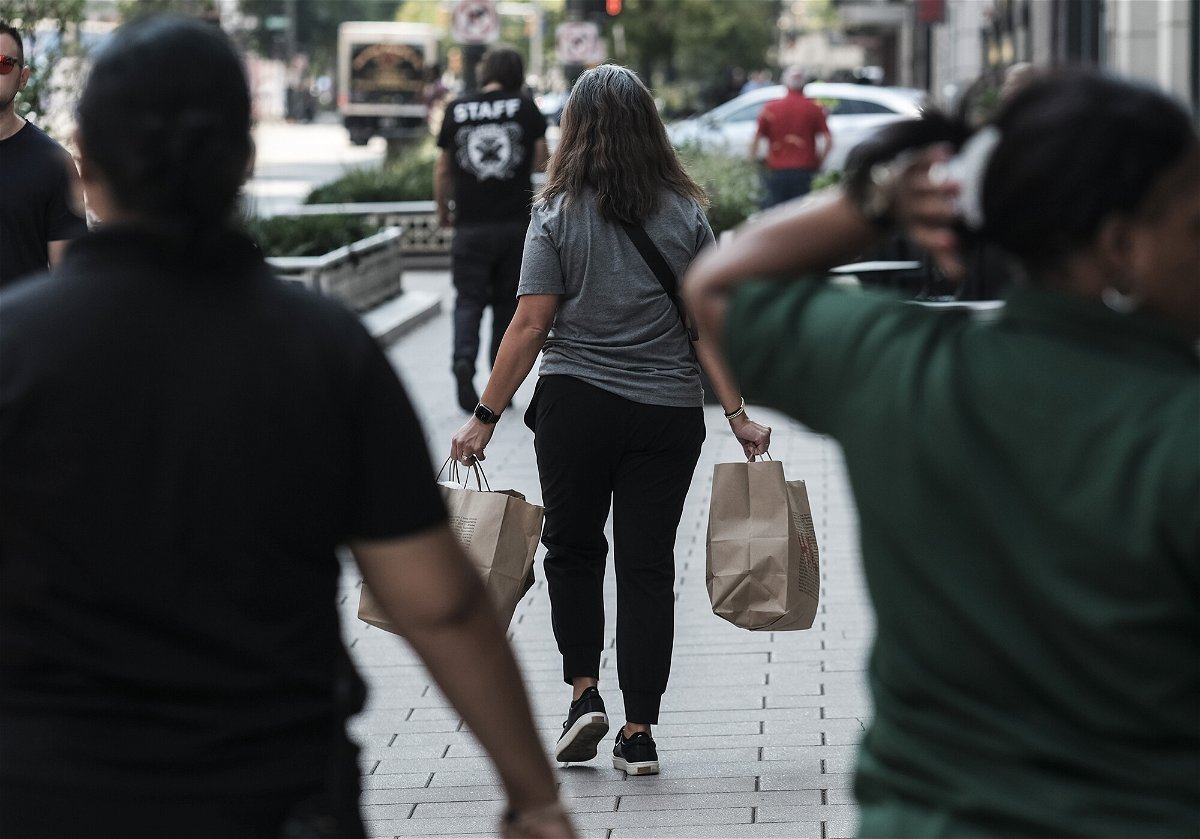 <i>Matthew Hatcher/Bloomberg/Getty Images</i><br/>Most corporate economists believe the United States is already in a recession. A shopper here carries bags in Detroit