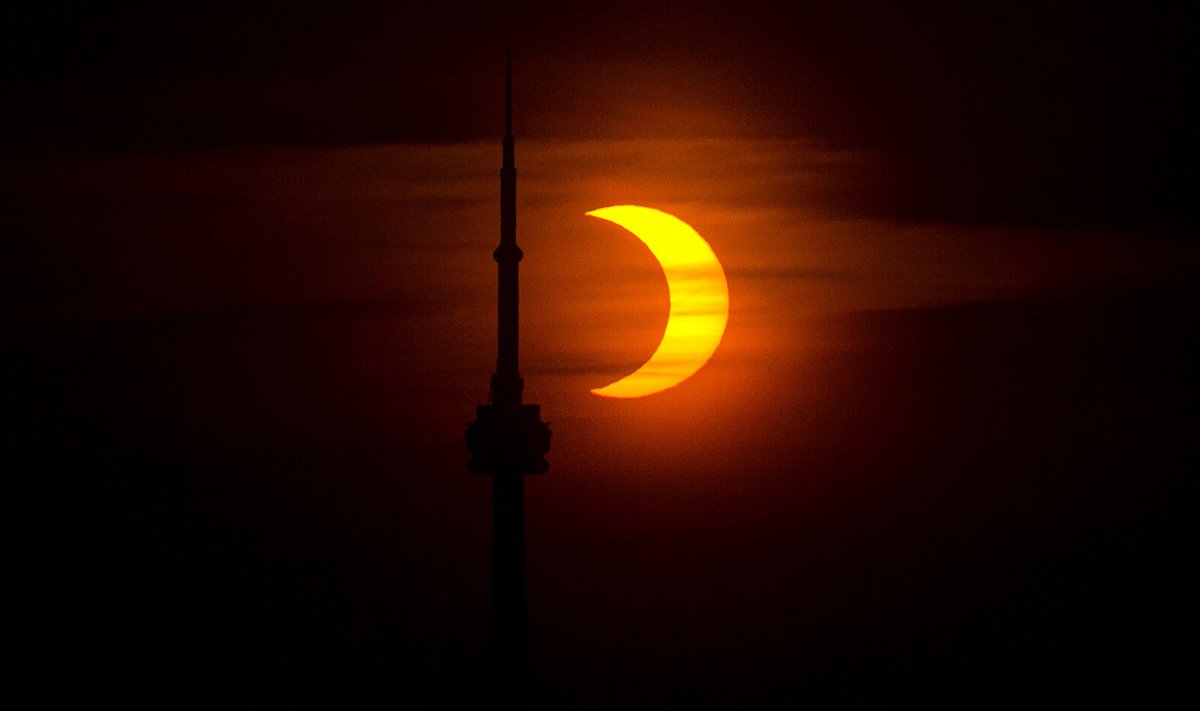 <i>Zou Zheng/Xinhua News Agency/Getty Images</i><br/>A partial solar eclipse is seen from Toronto