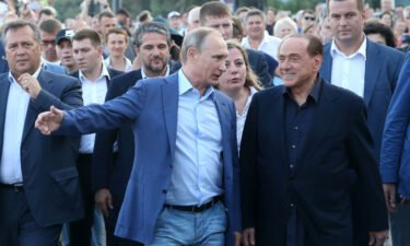 Russian President Vladimir Putin (center left) and former Italian Prime Minister Silvio Berlusconi on September 11